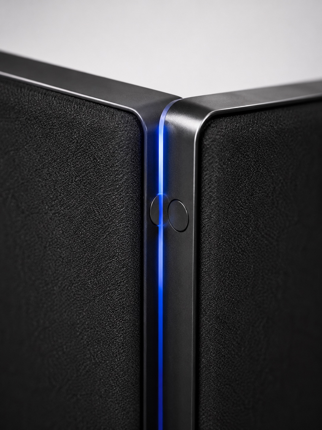 Macro detail of a matte-black Cognition panel — soft-touch acoustic fabric and a machined magnetic edge connector.